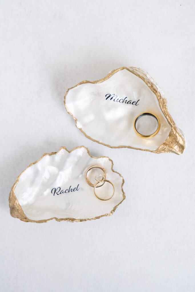 Custom oyster shell ring holders with wedding bands at a Lowcountry wedding on Dataw Island
