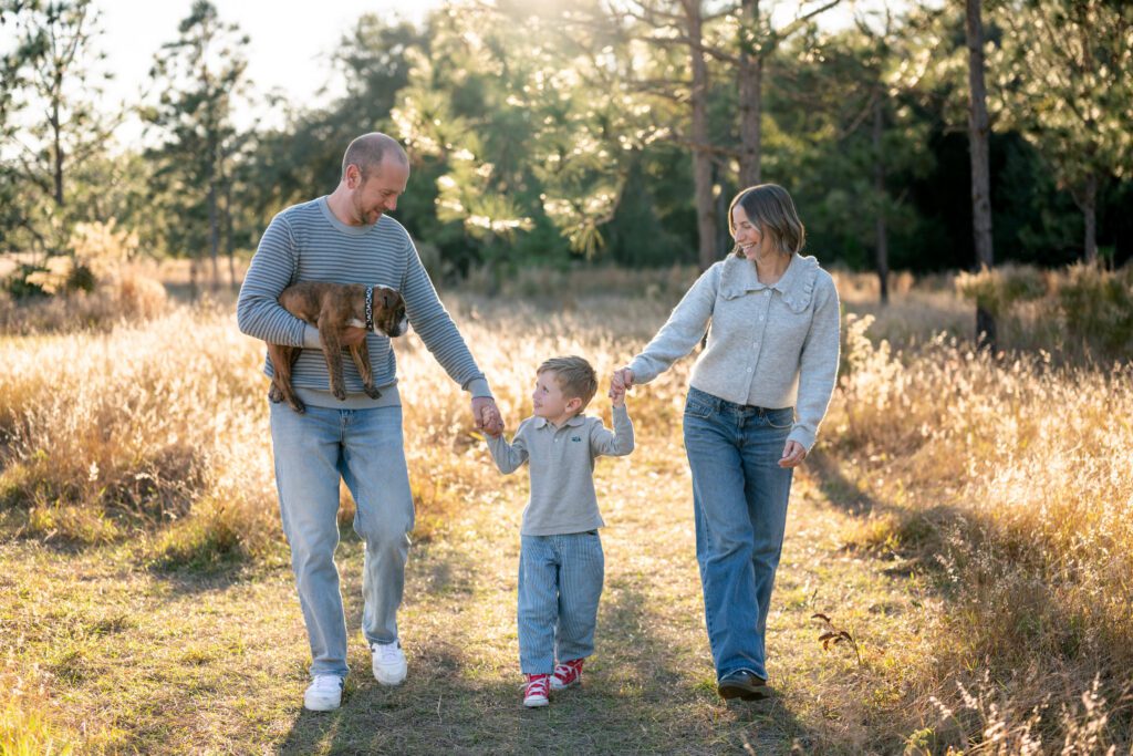 Lake Louisa State Park family photography session with parents walking with child in Clermont FL natural light