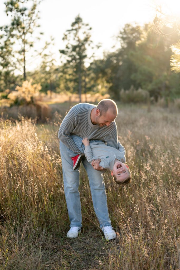 Father and son candid moment during Lake Louisa State Park Clermont family session in natural light