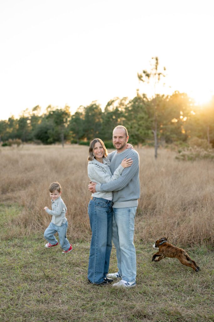 Lake Louisa State Park family photos with parents, child, and dog during golden hour in natural outdoor setting