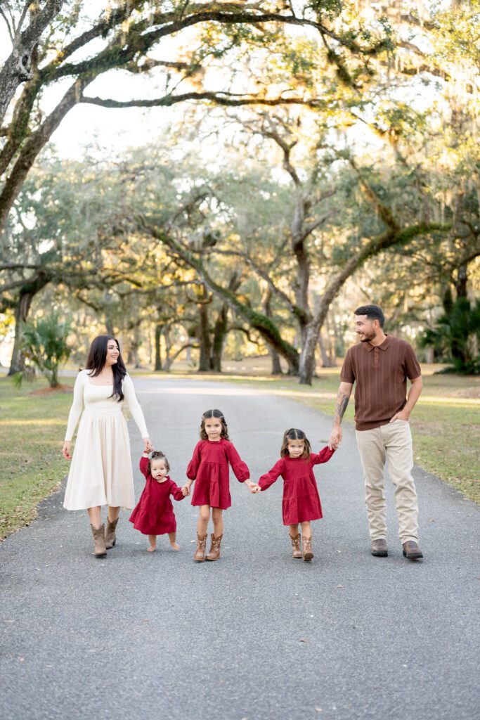 Moss Park Orlando family photography session with parents and children walking under oak trees in natural light