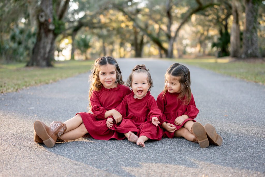 Siblings sitting together during Moss Park family portraits Orlando Florida outdoor session
