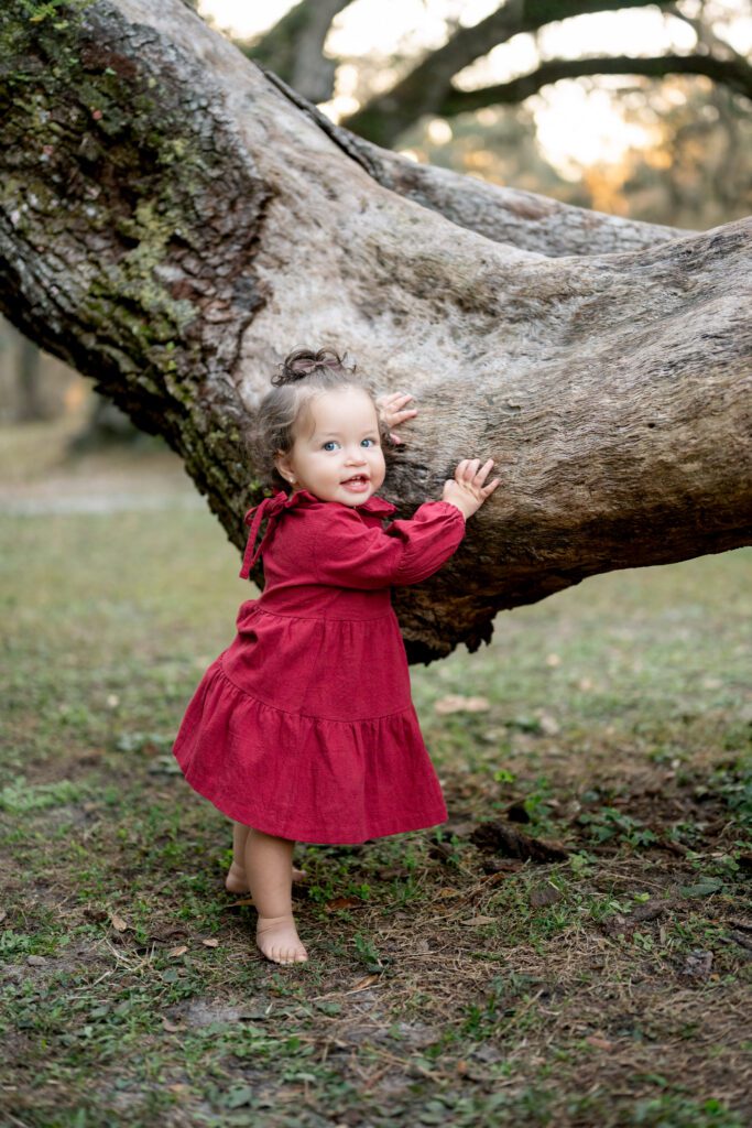 Child exploring nature during Moss Park Orlando family photography session in natural light