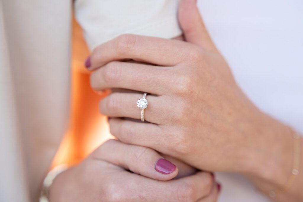 Close-up of a diamond engagement ring during Siesta Key Beach engagement photos, capturing timeless detail in soft coastal light