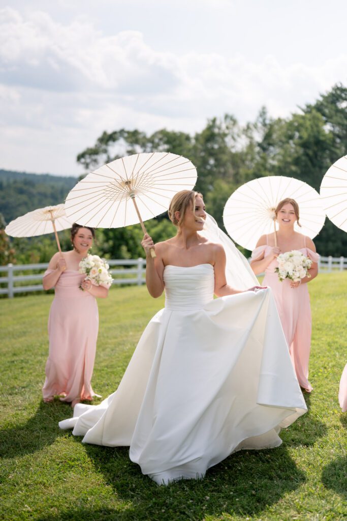 Summit on Cross Mountain wedding with bride and bridesmaids holding parasols at NC mountain wedding venue