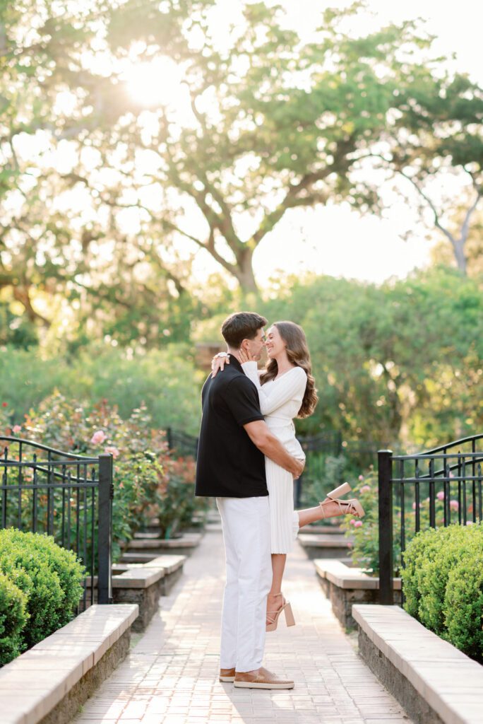Romantic couple embracing along a garden pathway during a Washington Oaks Gardens State Park engagement session in Palm Coast, Florida