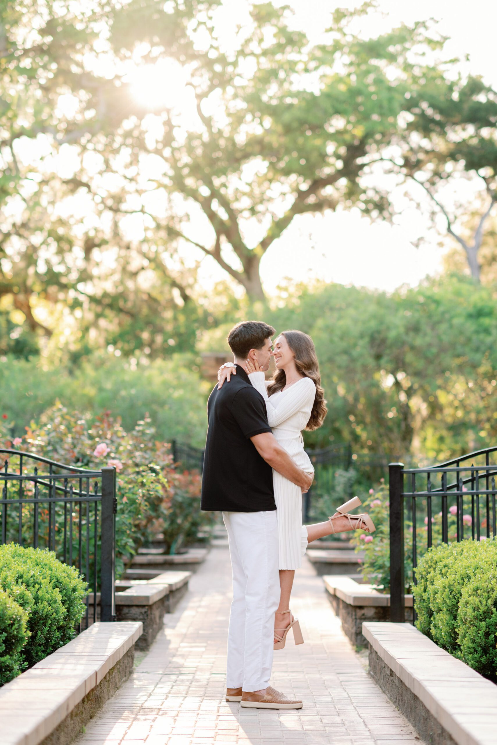 Romantic couple embracing along a garden pathway during a Washington Oaks Gardens State Park engagement session in Palm Coast, Florida