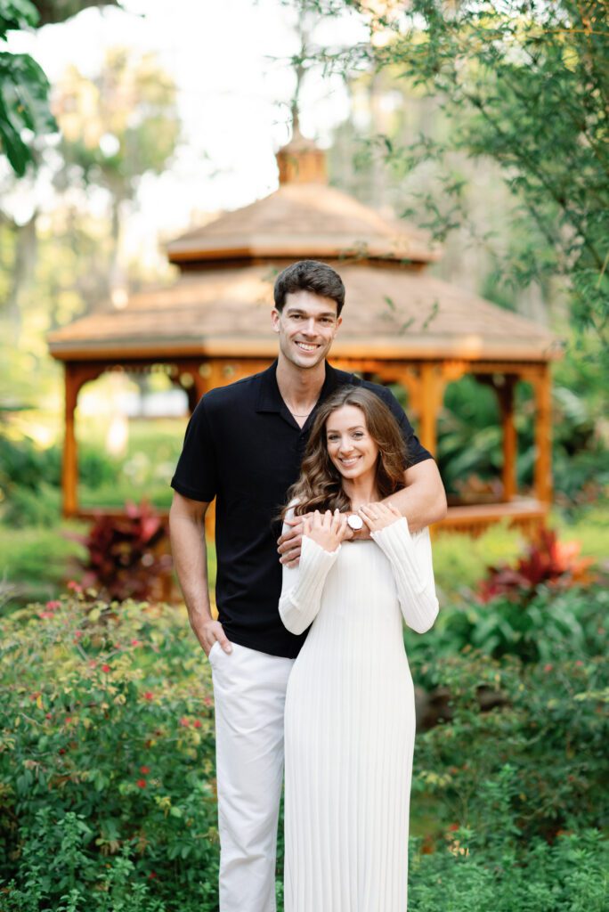 Romantic couple portrait in front of a garden gazebo during Washington Oaks Gardens State Park engagement photos in Flagler County
