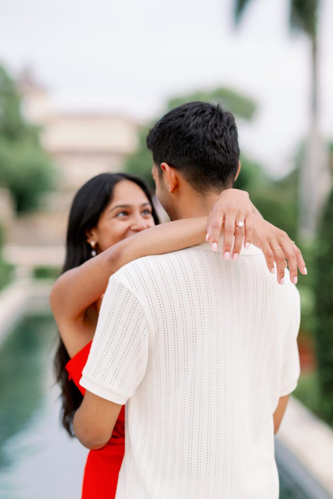 Close-up of a couple embracing with engagement ring visible after a Worth Avenue proposal along the Palm Beach waterfront