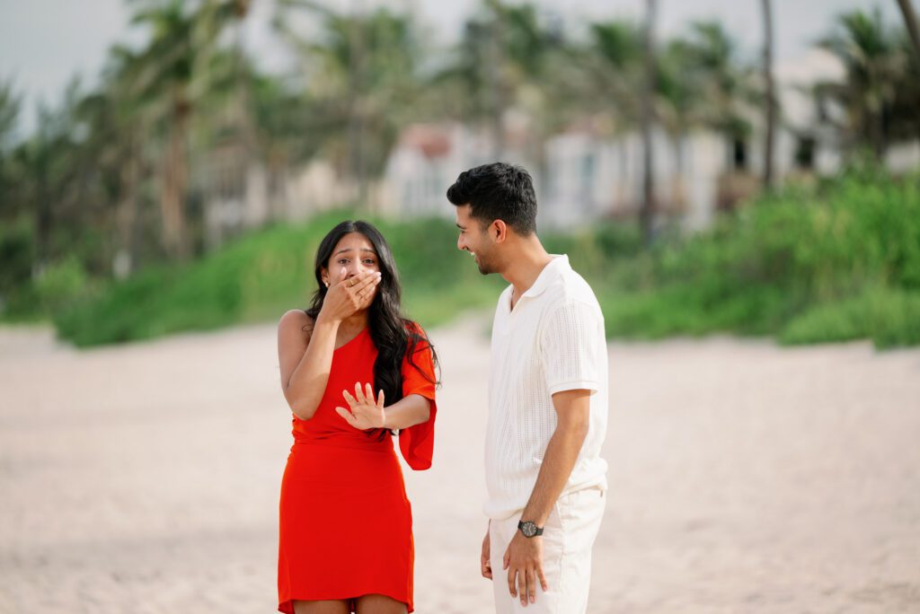 Emotional reaction after a Worth Avenue Clock Tower proposal with bride-to-be covering her mouth in surprise during a Palm Beach engagement moment